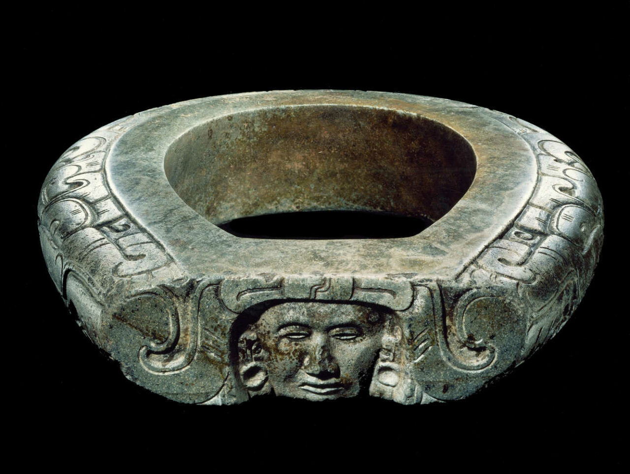 Ceinture cérémonielle en forme de joug fermé sculpté avec deux profils de dragons vis-à-vis encadrant un visage humain